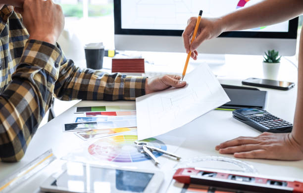 istock Team design of young Interior graphic designer working house project sketching on graphic tablet and color swatch working at modern office, creative inspiration and imagine 1263907182