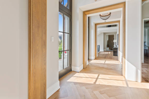 istock Front entrance of upscale home with corridors leading both ways 1263907973