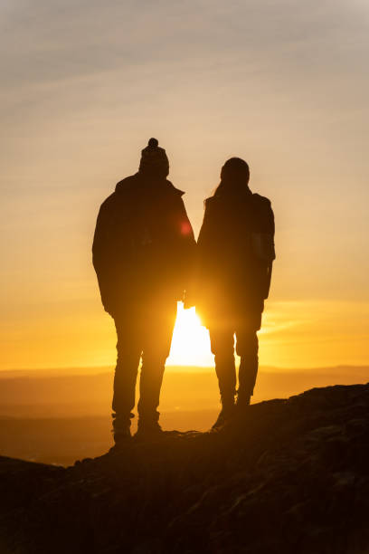 istock Rear view of couple looking at sunset 1263908161