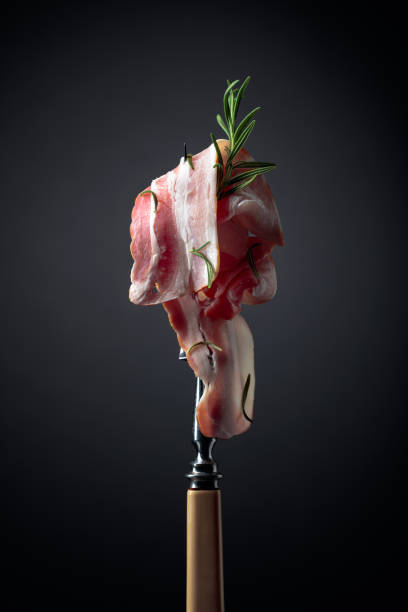 istock Bacon slices and rosemary on a fork. 1263909042