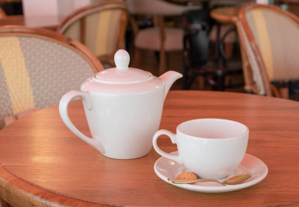 istock White porcelain teapot and tea cup stand on a table in a cafe 1263910491