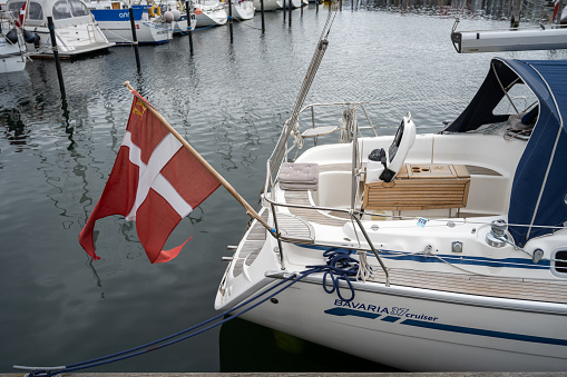 Hundested, Denmark - August 2, 2020: A danish flag in the back of a sailboat in the marina