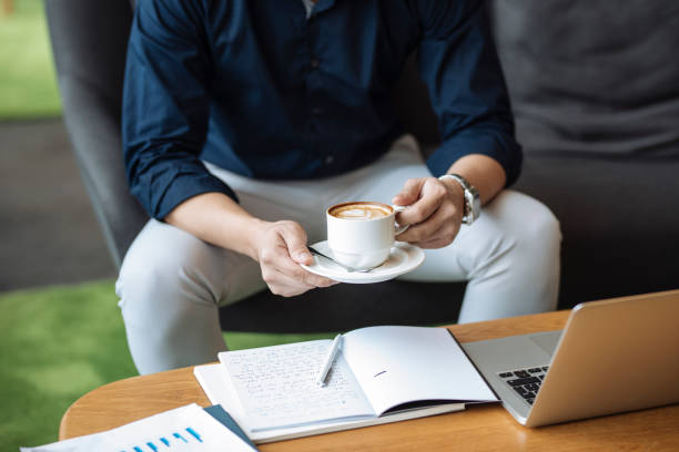istock Anonymous Businessman Drinking a Cappuccino During a Coffee Break, a Close Up 1263910674
