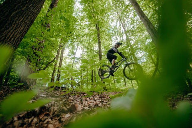 istock Man on mountain bike jumping over obstacles 1263911032