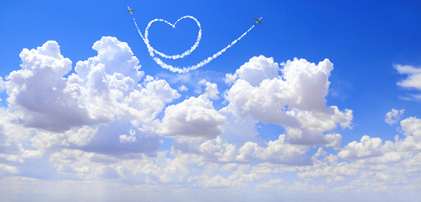 Two aircrafts draw a heart in the sky. Flight route of aircraft in shape of a heart. Love concept for traveling the world