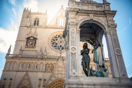 Majestic Saint-Jean-Baptiste Cathedral monument in Lyon old town, in Vieux Lyon district, with statue representing the baptism of Christ by John (St Jean). Photo taken in Lyon famous city, Unesco World Heritage Site, in Rhone department, Auvergne-Rhone-Alpes region in France, Europe during a sunny summer day.