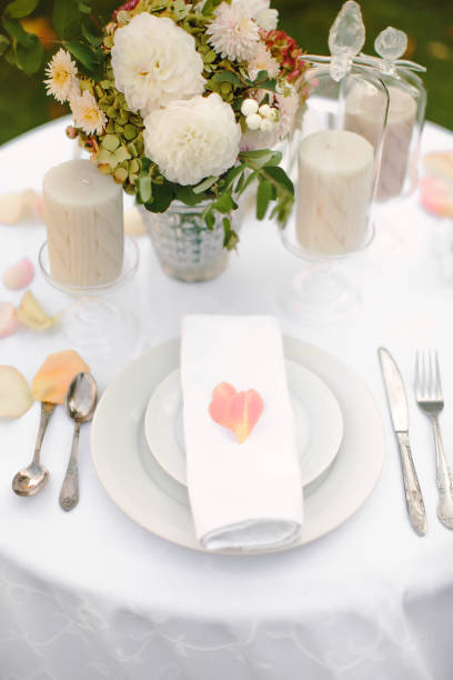 istock Festive table setting with rose petals. Summer dinner in nature. 1263912626