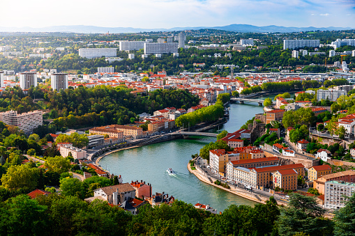 Aerial view of Lyon suburb, near Caluire and Fourviere hill, along Saone river with some residential buidings and boats sailing. Photo taken in Lyon famous city, Unesco World Heritage Site, in Rhone department, Auvergne-Rhone-Alpes region in France, Europe during a sunny summer day.
