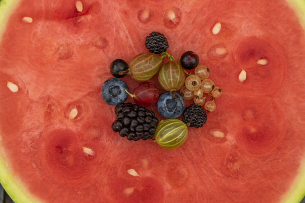 istock Mixed color garden fruit on red seedless water melone 1263914681