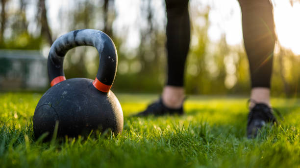 istock Close up of kettlebell on grass in sunset light 1263915574