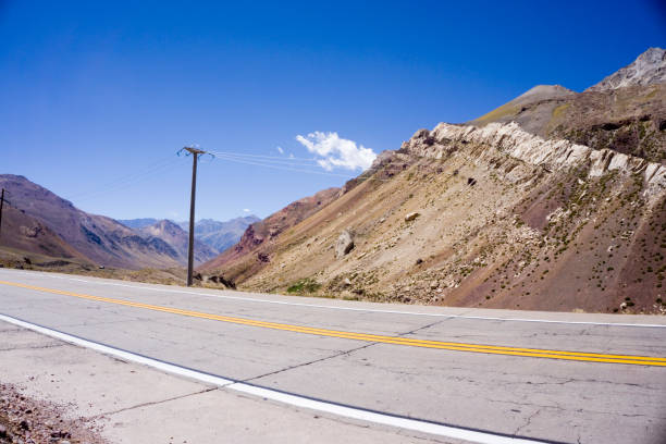 diagonal view of paved route with rocky mountain landscape stock photo