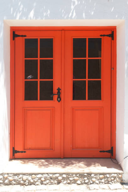 istock Orange colored wooden door 1263916025