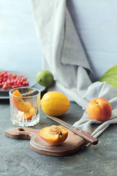 istock Peaches cut into slices, limes and lemons, berries on the table, for step by step preparation of detox water 1263916119