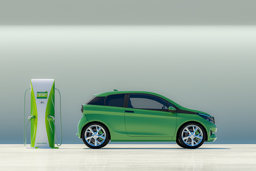 Modern electric car with electric charging station. Vehicle and charging station are not based on any real brands or model - custom modeled and designed.