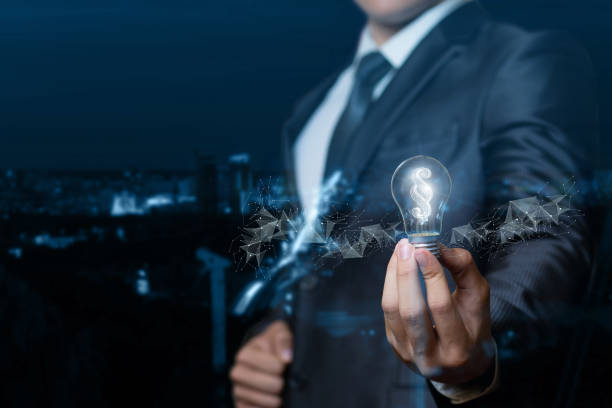 A lawyer or businessman showing light bulb burning inside the paragraph . A lawyer or businessman showing light bulb burning inside the paragraph on blurred background. paragraph stock pictures, royalty-free photos & images