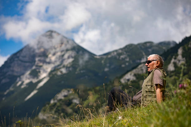 istock Active Senior Man Resting on a Hiking Trip in Mountains 1263917439