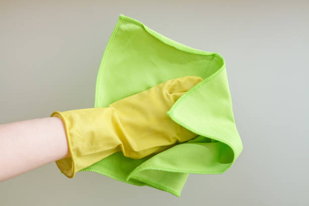 istock Hands with a duster cleaning the glass. Closeup 1263921239
