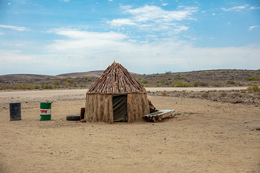View of tribal hut in barren landscape