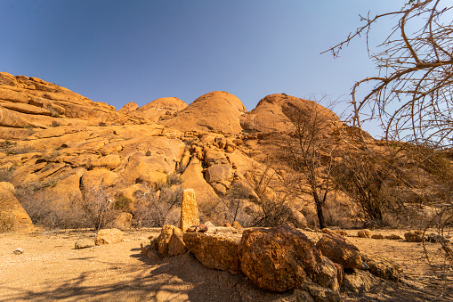 Rock formation cliff in desert with landmark close by