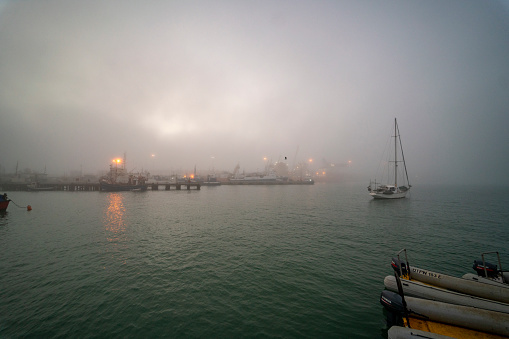 Clouds and fog over small harbor
