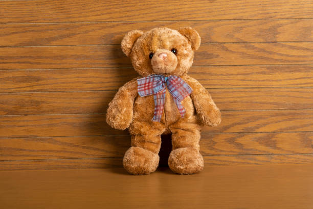 istock teddy bear with shadow on wooden background 1263924929