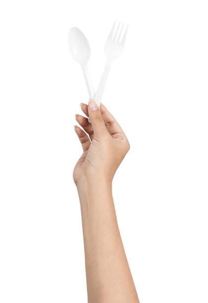 istock hand holding disposable cutlery 1263925707