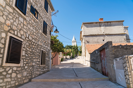 Pedestrian street and houses made of stone in Primosten, famous touristic destination, Dalmatia, Croatia