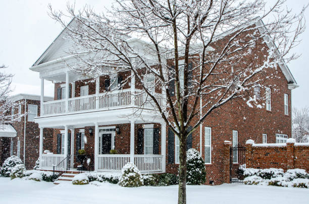 istock Winter Scene: Traditional Brick Home During a Winter Snow Storm 1263927986