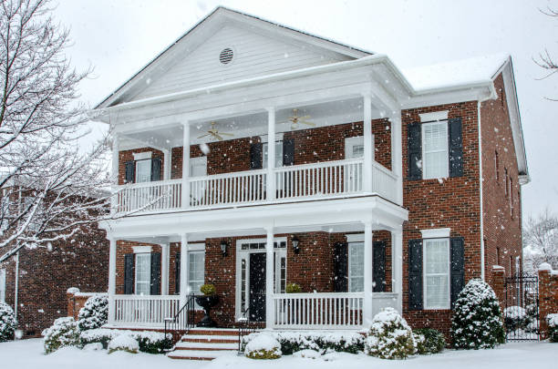 istock Winter Scene: Traditional Brick Home During a Winter Snow Storm 1263927988