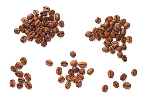 Coffee beans isolated on white background. Heaps of roasted arabica. View from above