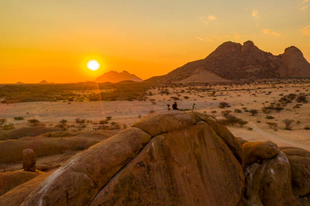 istock Sun rising over arid climate landscape, Spitzkoppe, Namibia, Africa 1263928873