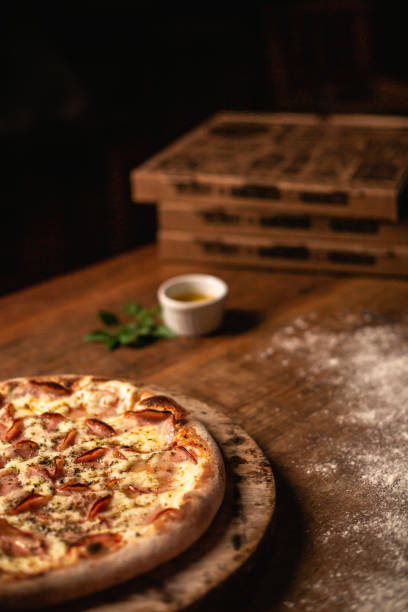 istock Delicious pizza on wood table 1263928984