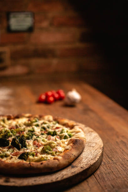 istock Delicious pizza on wood table 1263929012