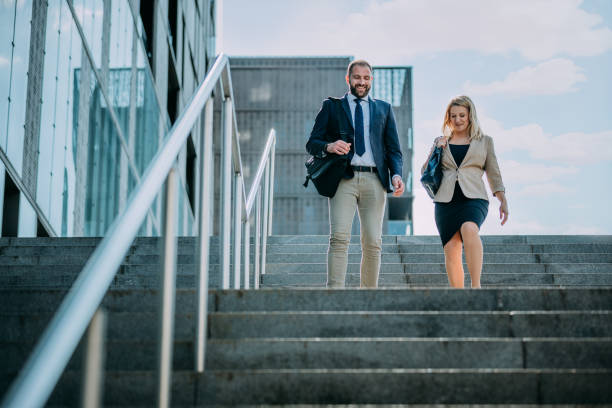 istock Man and woman walking downstairs 1263930516