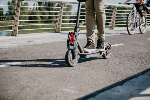 istock People on electric push scooter and bicycle 1263932060