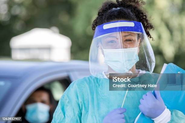 Nurse Wearing Ppe Smiles At Drive Through Testing Site Stock Photo - Download Image Now