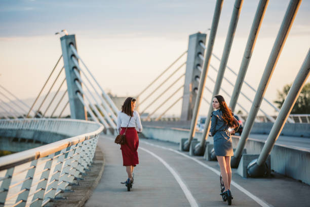 istock Sisters on electric push scooters 1263933971