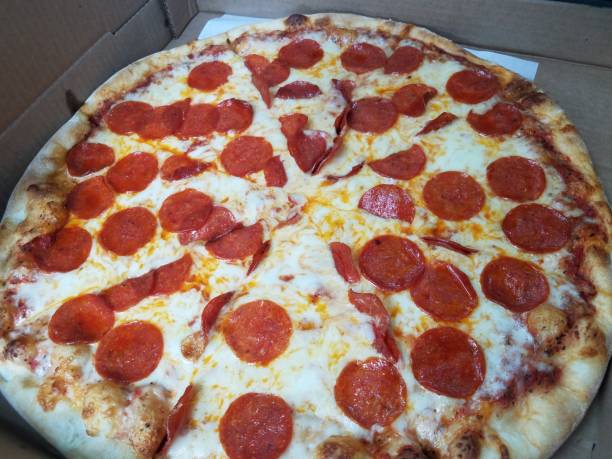 istock sliced pizza with pepperoni and cheese in box 1263935456