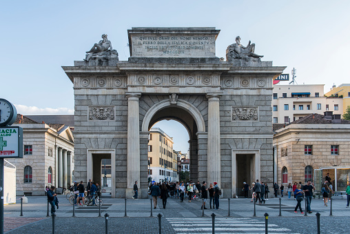 People walking next to the Porta Garibaldi (Garibaldi Gate) at Milan, Italy.