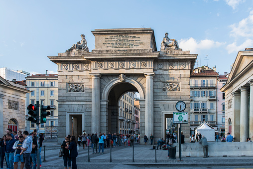 People walking next to the Porta Garibaldi (Garibaldi Gate) at Milan, Italy.