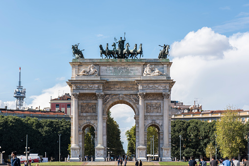 People walking next to the Porta Sempione (Sempione Gate) also know as Porta della Pace (Peace Gate) at Milano city, Italy.