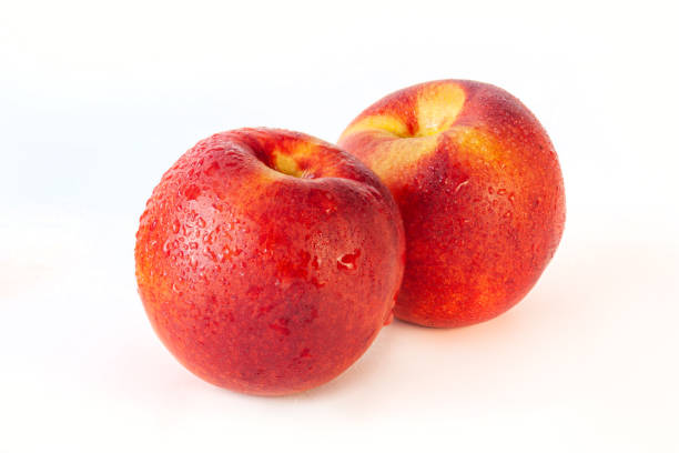 istock Peach or nectarine and peach slice with leaf on white background 1263937633