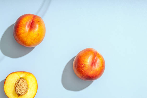 istock Peach or nectarine and peach slice with leaf on white background 1263938635