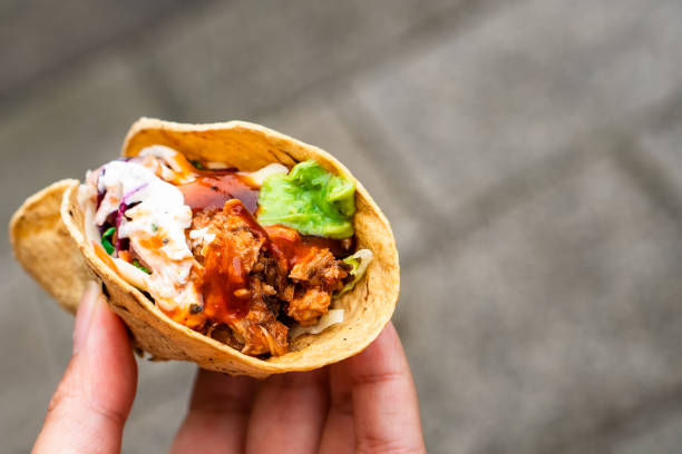 istock Mexican traditional authentic homemade tacos with pulled pork beef chili con carne serve with tomato salad and avocado guacamole and dip sauce 1263938771