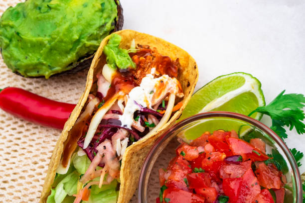 istock Mexican traditional authentic homemade tacos with pulled pork beef chili con carne serve with tomato salad and avocado guacamole and dip sauce 1263938818