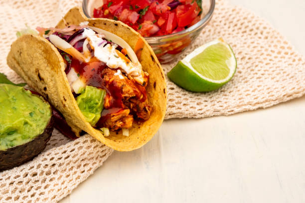 istock Mexican traditional authentic homemade tacos with pulled pork beef chili con carne serve with tomato salad and avocado guacamole and dip sauce 1263938873
