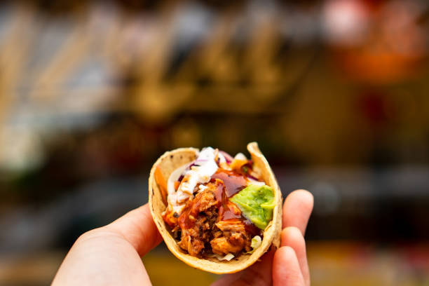 istock Mexican traditional authentic homemade tacos with pulled pork beef chili con carne serve with tomato salad and avocado guacamole and dip sauce 1263938889