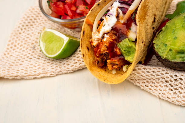istock Mexican traditional authentic homemade tacos with pulled pork beef chili con carne serve with tomato salad and avocado guacamole and dip sauce 1263938891