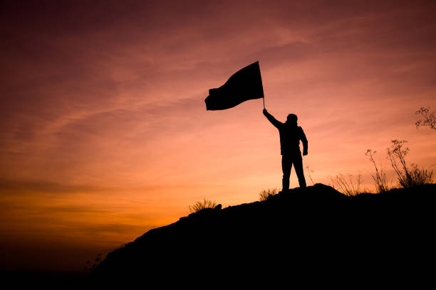 istock man hand flag in mountain 1263940667