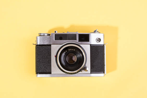 istock film camera isolated on yellow background 1263941464